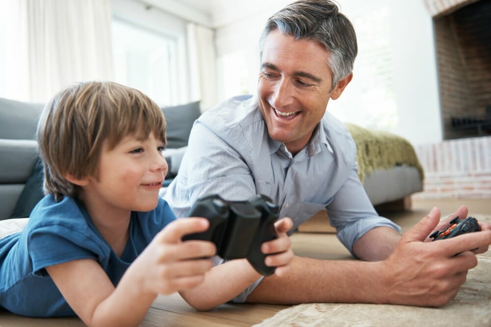 Shot of a father and son having fun playing video games at home